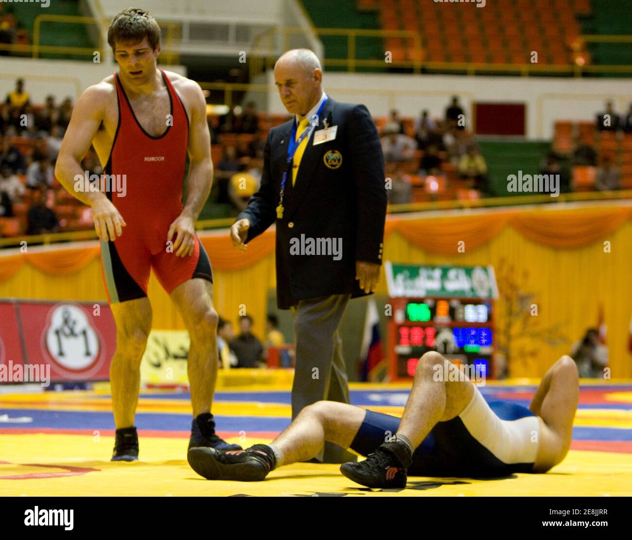 Michal Tamillow of the U.S. (in red) wins over Houman Sheida on their match in the 96kg weight class of the 29th Takhti Free Style Wrestling Tournament in Tehran March 12, 2009. REUTERS/Raheb Homavandi (IRAN SPORT WRESTLING POLITICS) Stock Photo