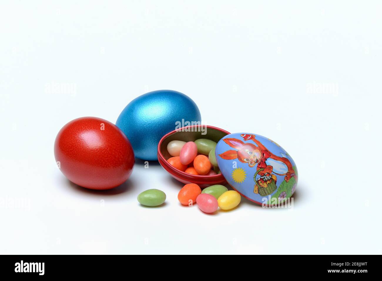 Easter eggs and sugar eggs in tin egg with rabbit figure Stock Photo