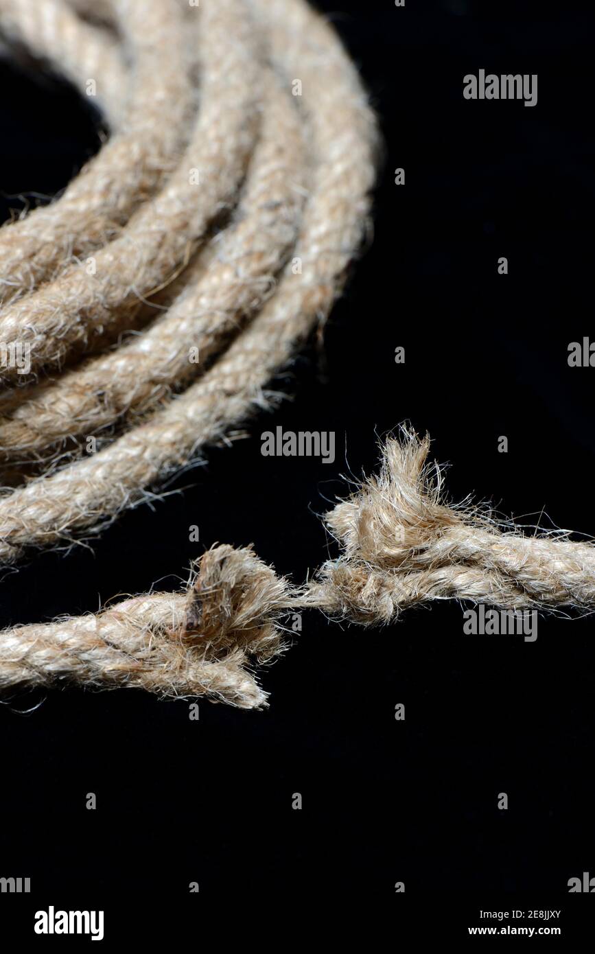 Defective jute rope, on a silk thread, torn, frayed Stock Photo - Alamy