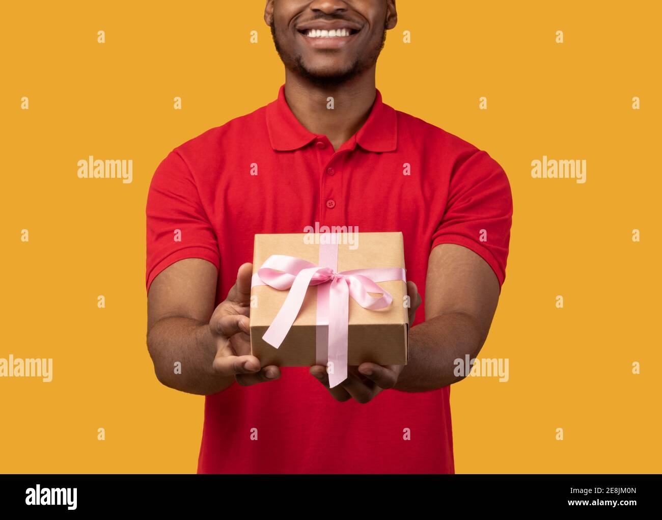 Black guy holding gift box showing to camera Stock Photo