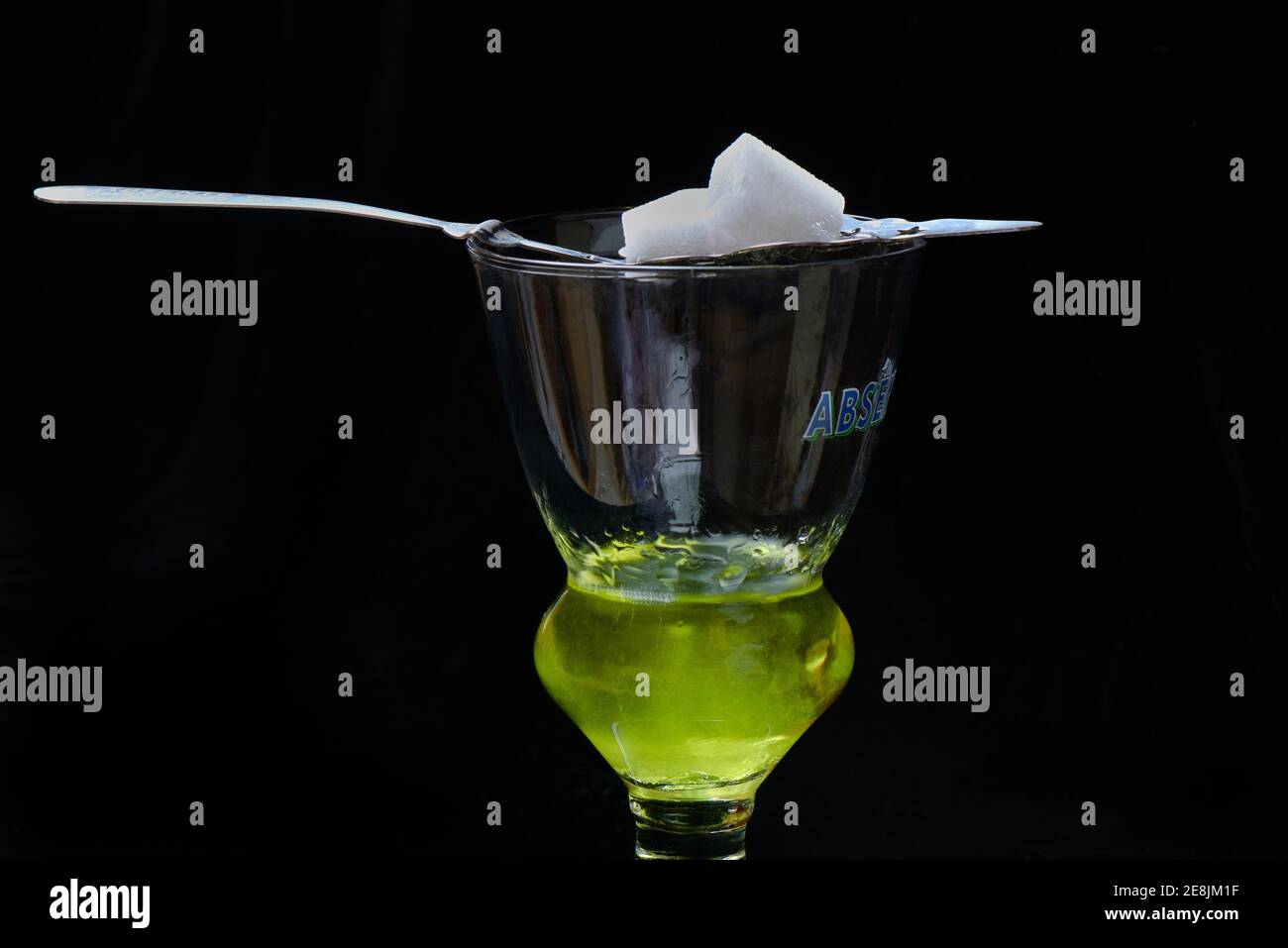 Glass of absinthe with absinthe spoon and sugar cubes, Green Fairy Stock Photo