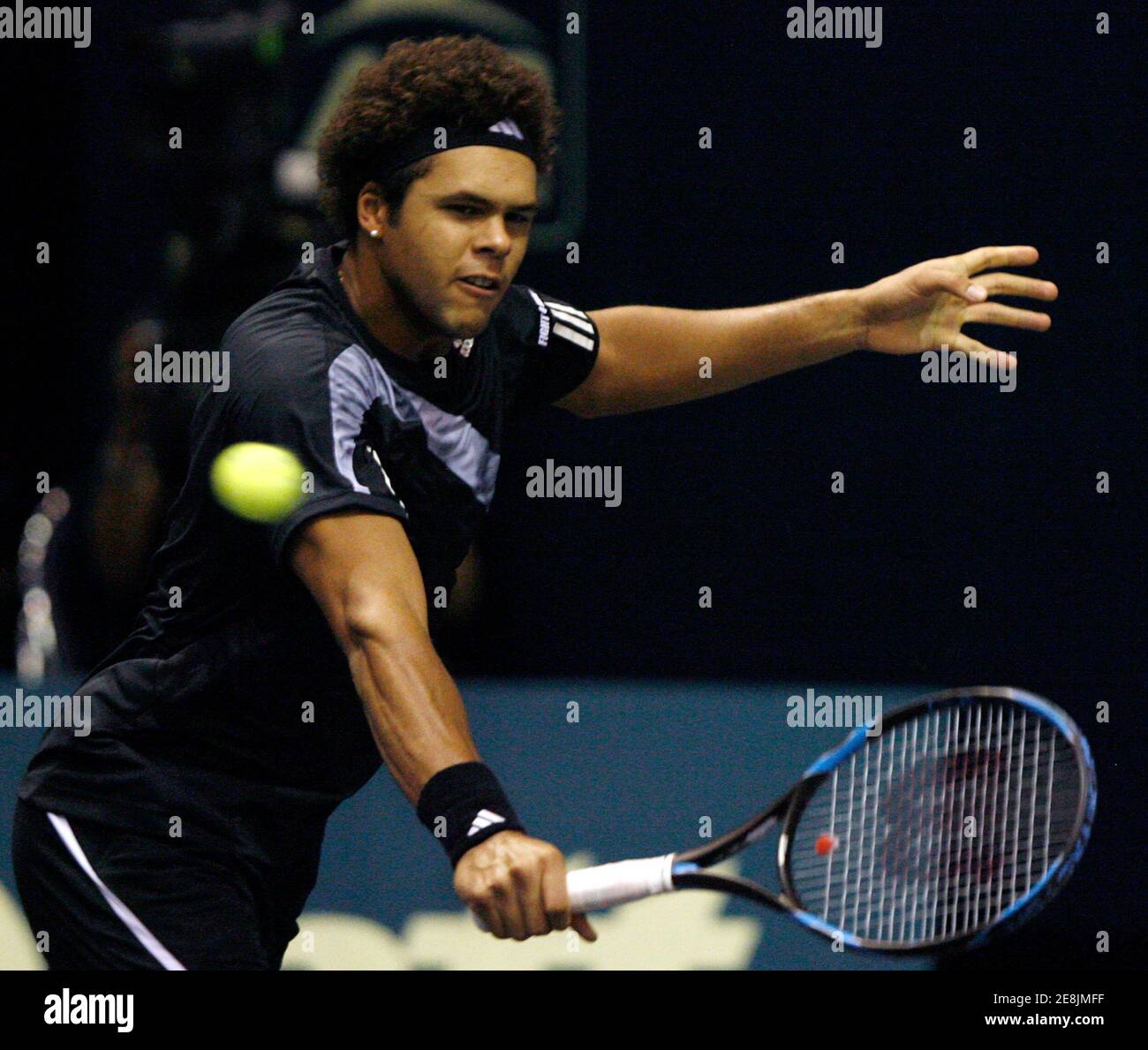 Jo-Wilfried Tsonga of France returns a shot to Ernests Gulbis of Latvia during their second round match at Thailand Open tennis tournament in Bangkok October 1, 2009. REUTERS/Chaiwat Subprasom (THAILAND SPORT TENNIS) Stock Photo