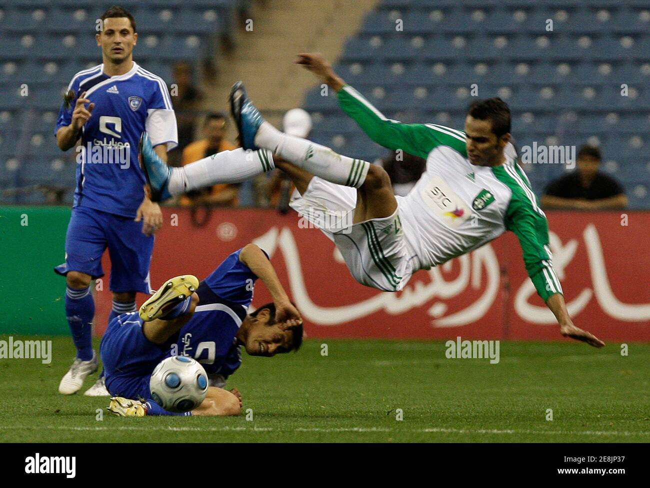 Al-Hilal's Lee Young Pyo (L) challenges Al-Ahli's Muhammad Al Safri during their Saudi Crown Prince Cup final soccer match in Riyadh February 19, 2010. REUTERS/Fahad Shadeed (SAUDI ARABIA - Tags: SPORT SOCCER) Stock Photo