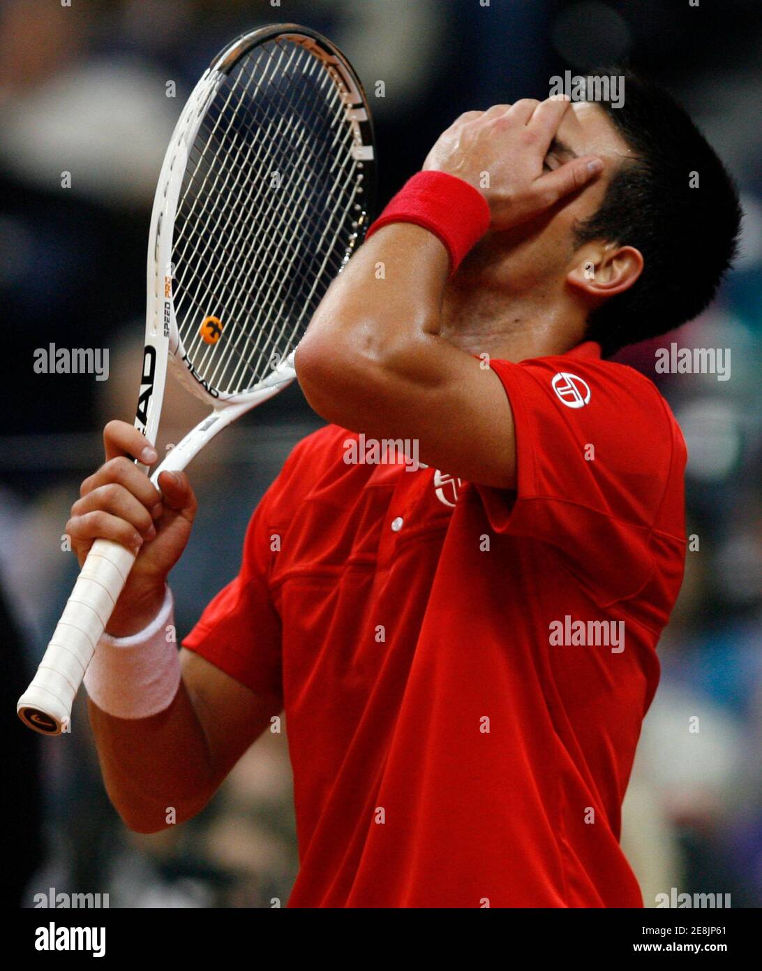 Serbia's Novak Djokovic reacts during his game against Sam Querrey of the U.S. during their Davis Cup World Group tennis match in Belgrade March 5, 2010.   REUTERS/Ivan Milutinovic (SERBIA - Tags: SPORT TENNIS) Stock Photo