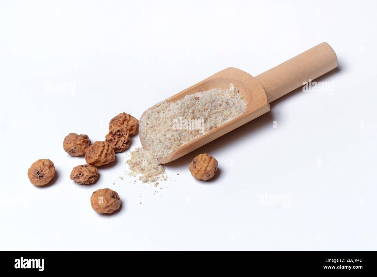 Tigernuts and tigernut flour in wooden shovel, Cyperus esculentus Stock Photo