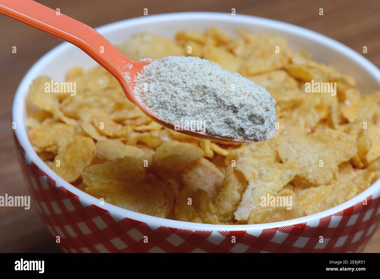 Tigernut flour in spoon and cornflakes in shell, Cyperus esculentus Stock Photo