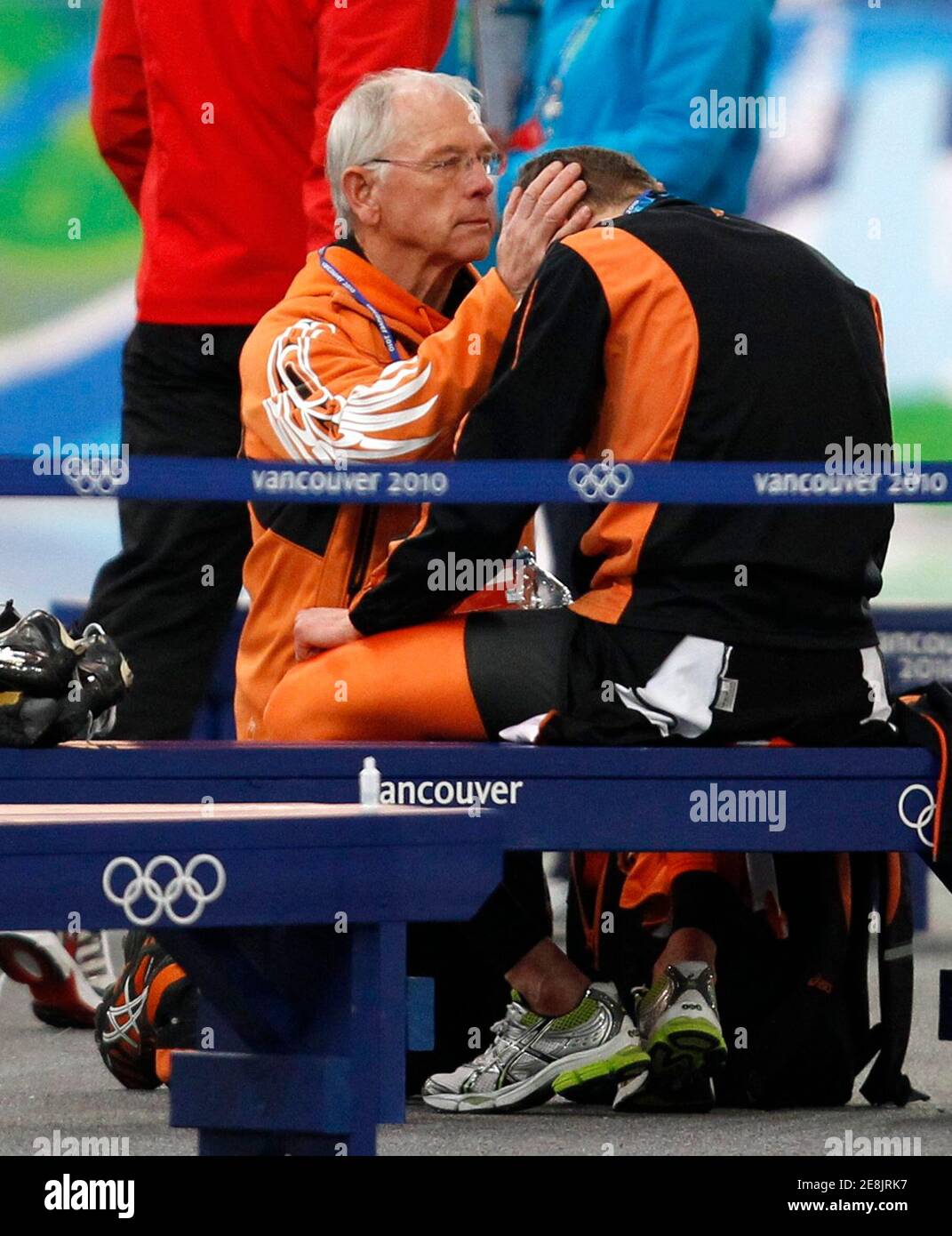 Sven Kramer (R) of the Netherlands is comforted by former Dutch national speed skating coach Henk Gemser after his disqualification in the men's 10000 metres race at the Richmond Olympic Oval during the Vancouver 2010 Winter Olympics February 23, 2010.     REUTERS/Jerry Lampen (CANADA) Stock Photo