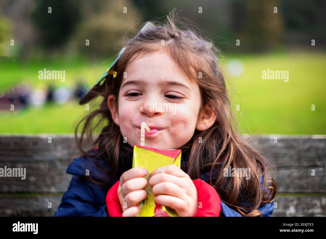 joyful baby girl picnic - health nutrition fruit juice Stock Photo