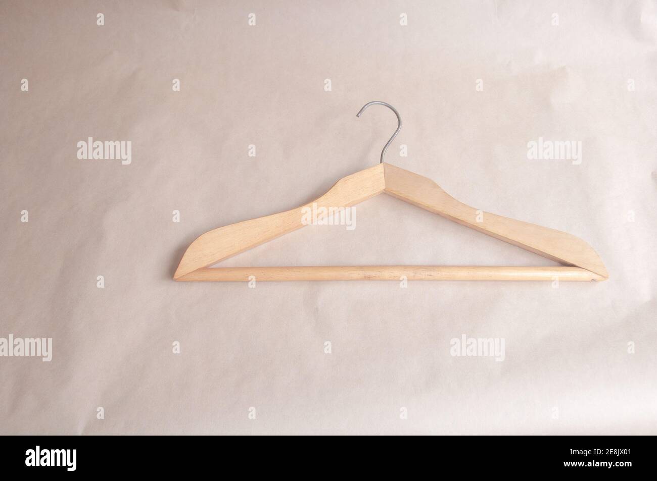 clothes hanger in a minimalist style on a beige background Stock Photo