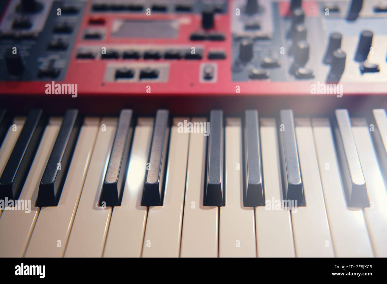 Black and white electronic piano keys, red modern synthesizer with sliders  and buttons Stock Photo - Alamy