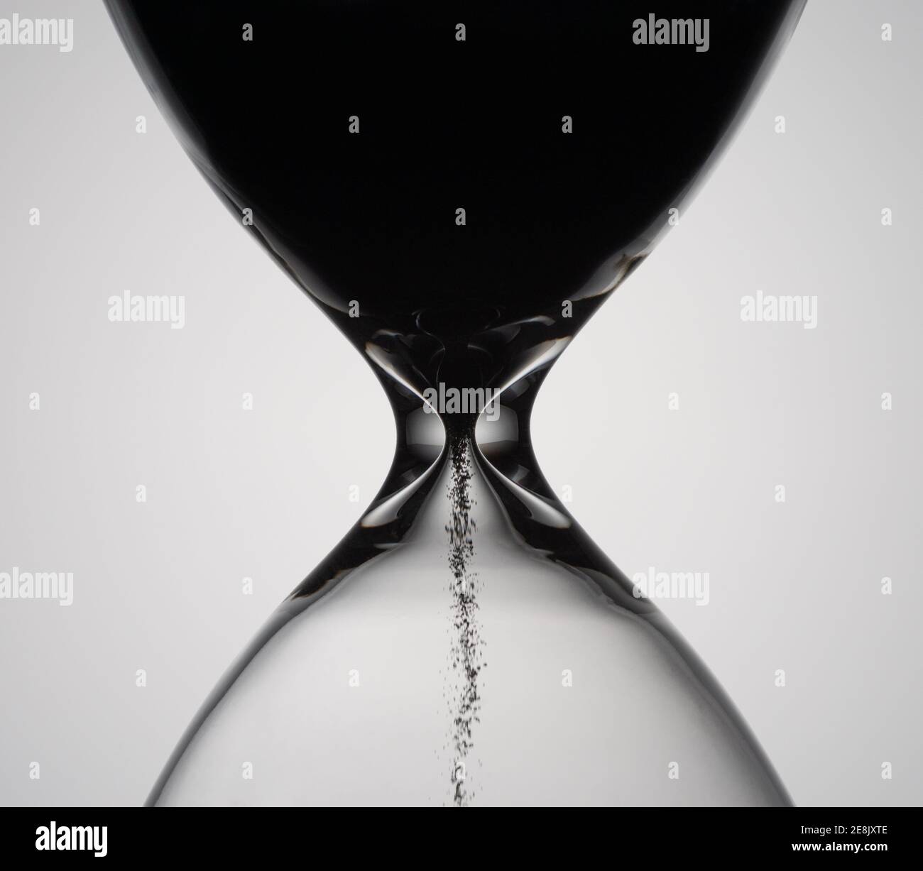 Sand moves through hourglass. Close up of hour glass clock. Old time classic sandglass timer. Hourglass as time passing concept for business deadline, Stock Photo