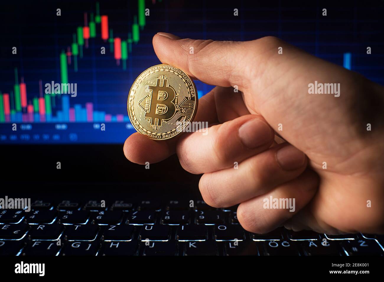 Business men holding golden bitcoin on computer trading chart background.  Bitcoin as most important cryptocurrency concept Stock Photo - Alamy