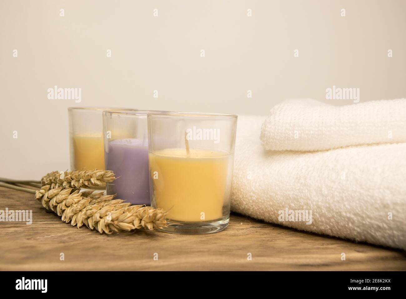 Three aromatherapy candles with white towels Stock Photo Alamy