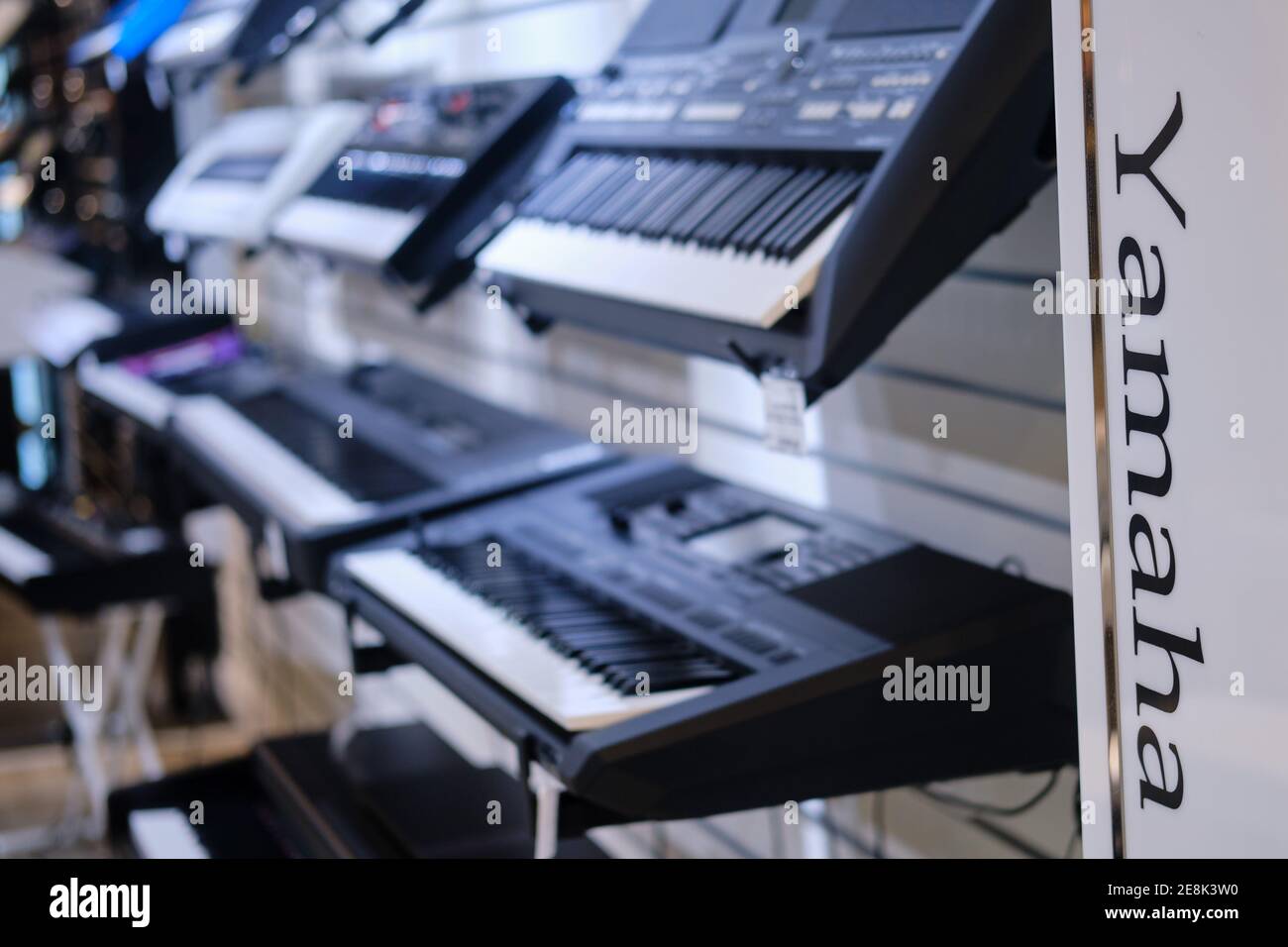 Black electronic piano Yamaha, synthesizers in musical store. Stock Photo