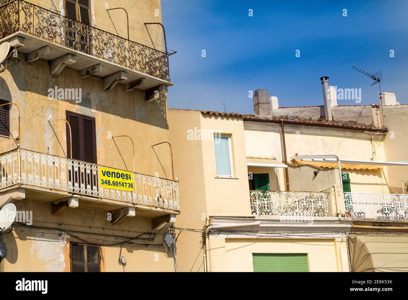 Apartment for Sale,  Exterior Image of Upper Apartments, Louvred Shutters, Building in the Main Street of La Maddalena,  Island of La Maddalena, Italy Stock Photo