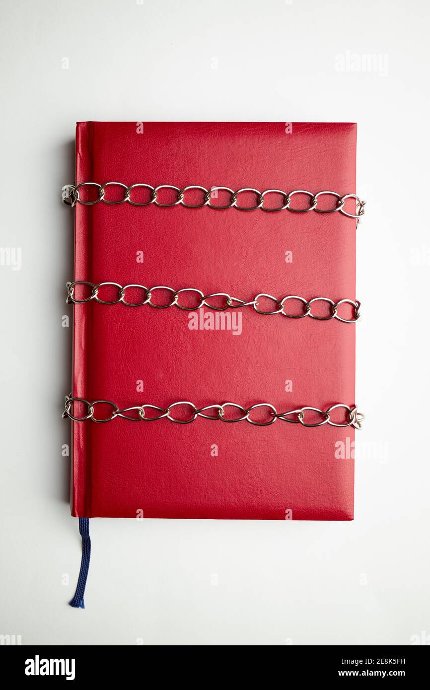 red empty book or diary in chains. information security concept. top view Stock Photo