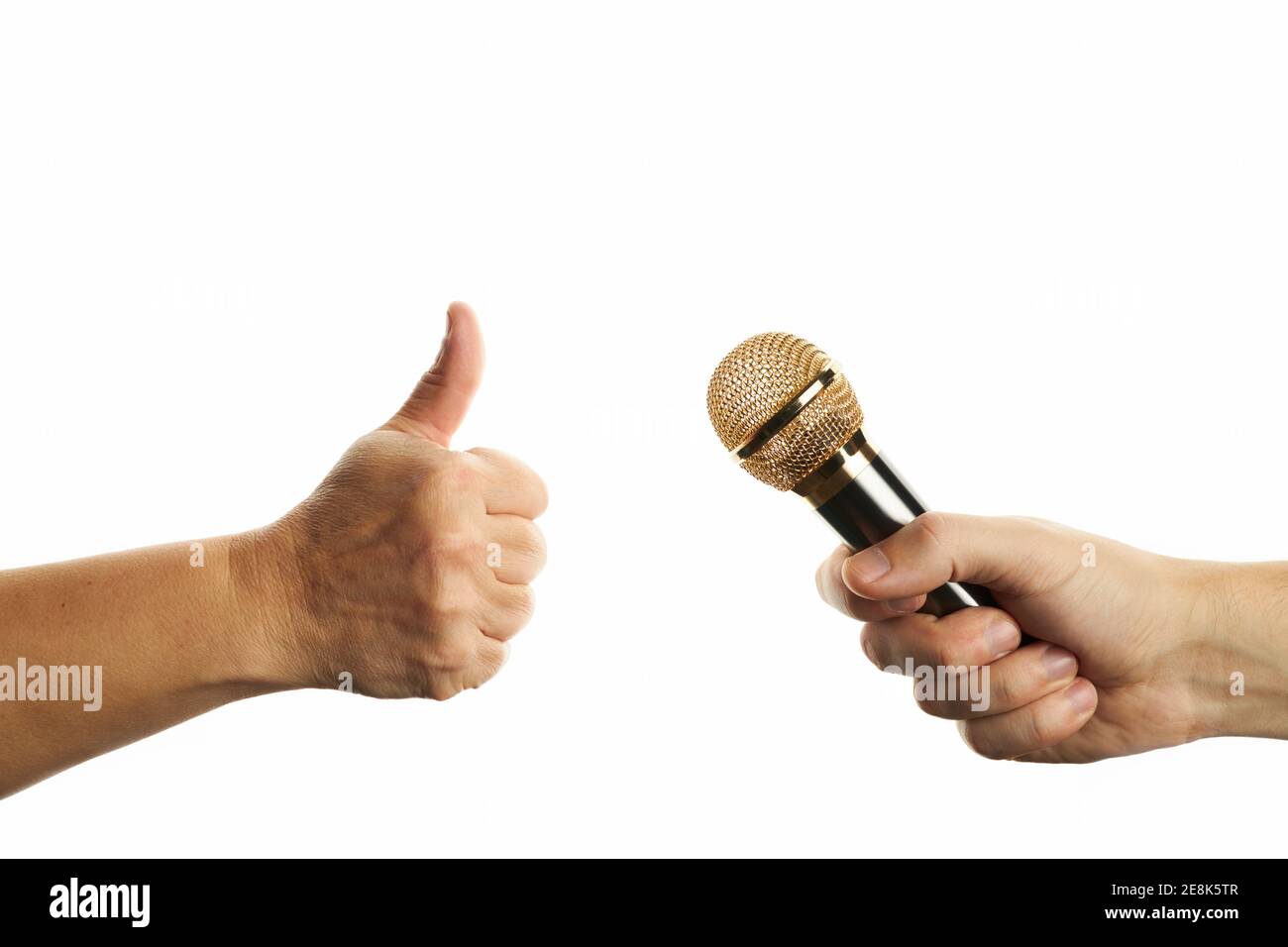 male person hold golden microphone. female person showing thumbs up gesture isolated on a white background. positive and success emotion Stock Photo