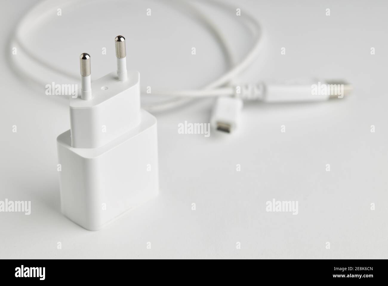 white usb charge or power adapter with usb wire at background. charging portable information devices Stock Photo