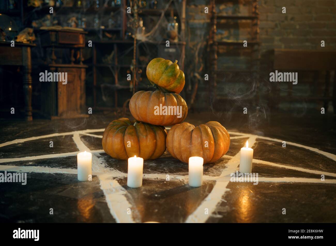 Magic circle with pumpkins and burning candles Stock Photo