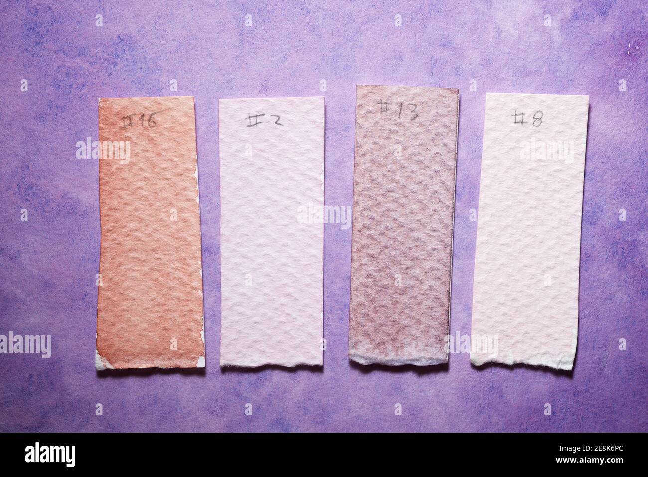 Watercolor test cards on a painted paper Stock Photo - Alamy