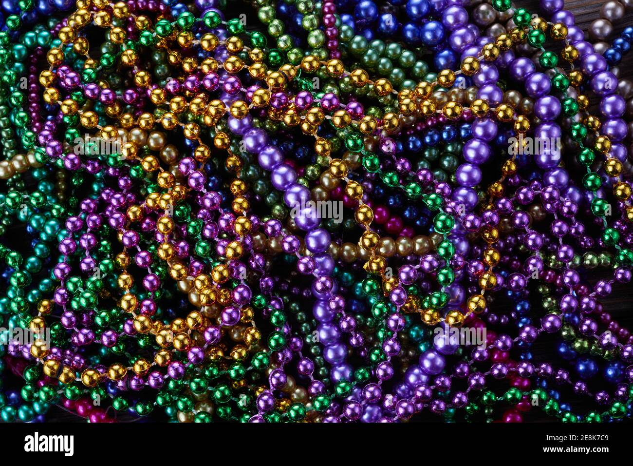 Colorful Mardi gras beads background. Green, purple and gold Merdi gras  beads Stock Photo - Alamy