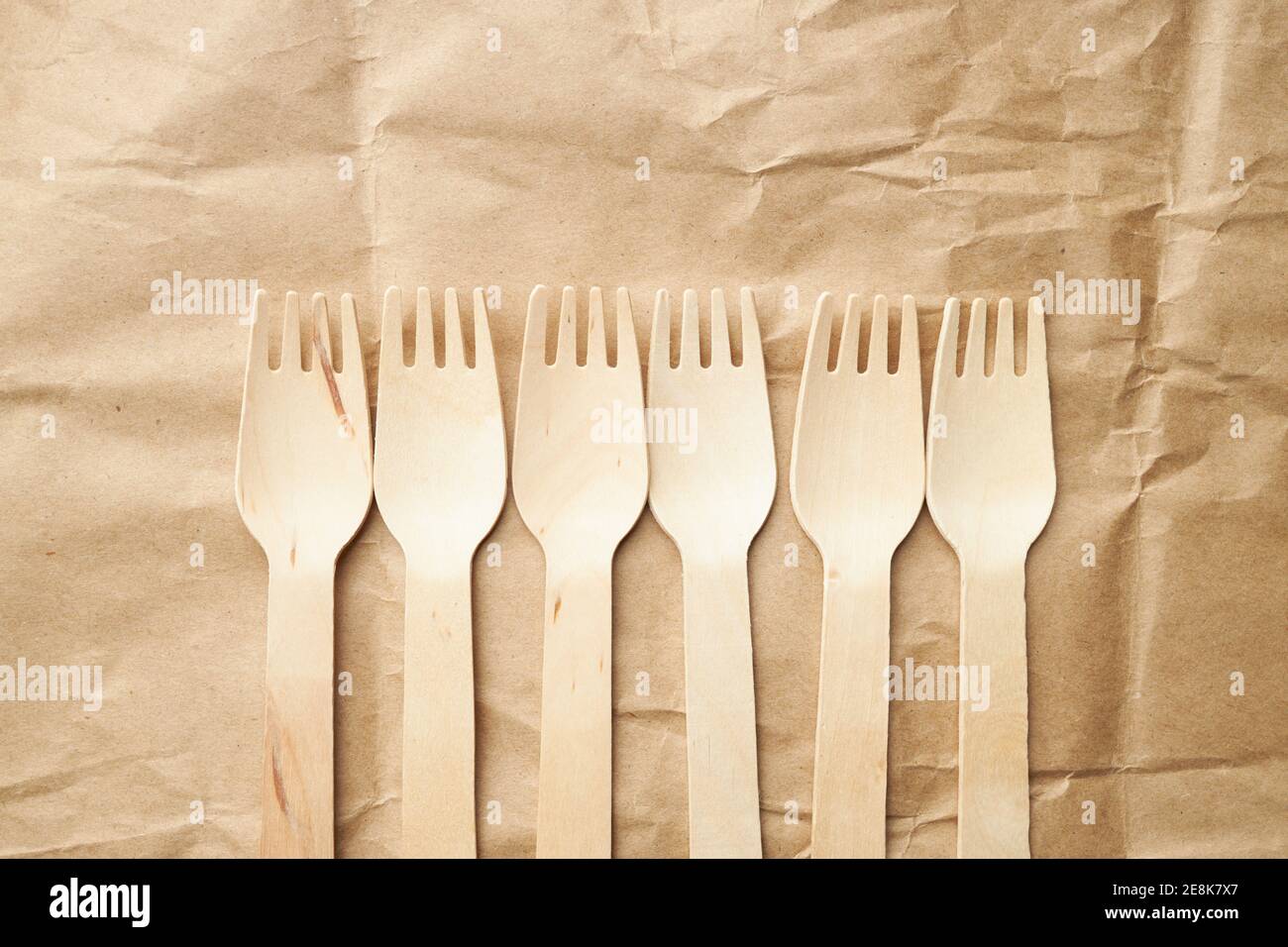 eco friendly disposable kitchenware utensils on paper background. look from above. wooden forks. eco friendly concept. copy space Stock Photo