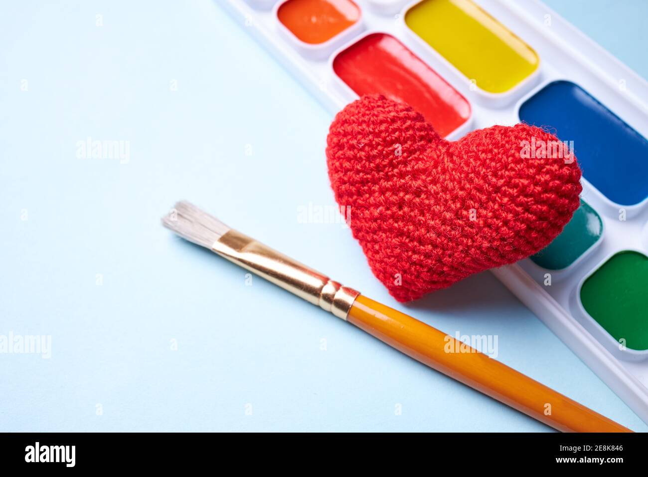 a paints with tassel with heart shape. copy space for text. love to creativity concept Stock Photo