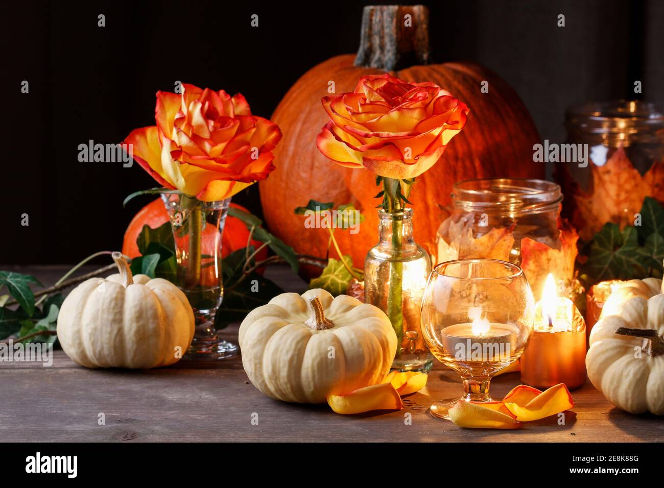 Autumn wedding decoration with pumpkins, orange roses and candles. Party  decor Stock Photo - Alamy, image size:1300x956