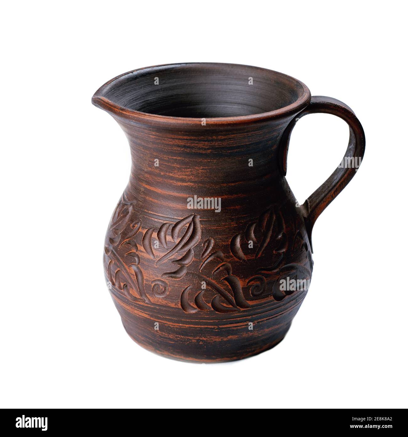 ceramic jug with handle isolated on white background. handicraft pattern on pot Stock Photo