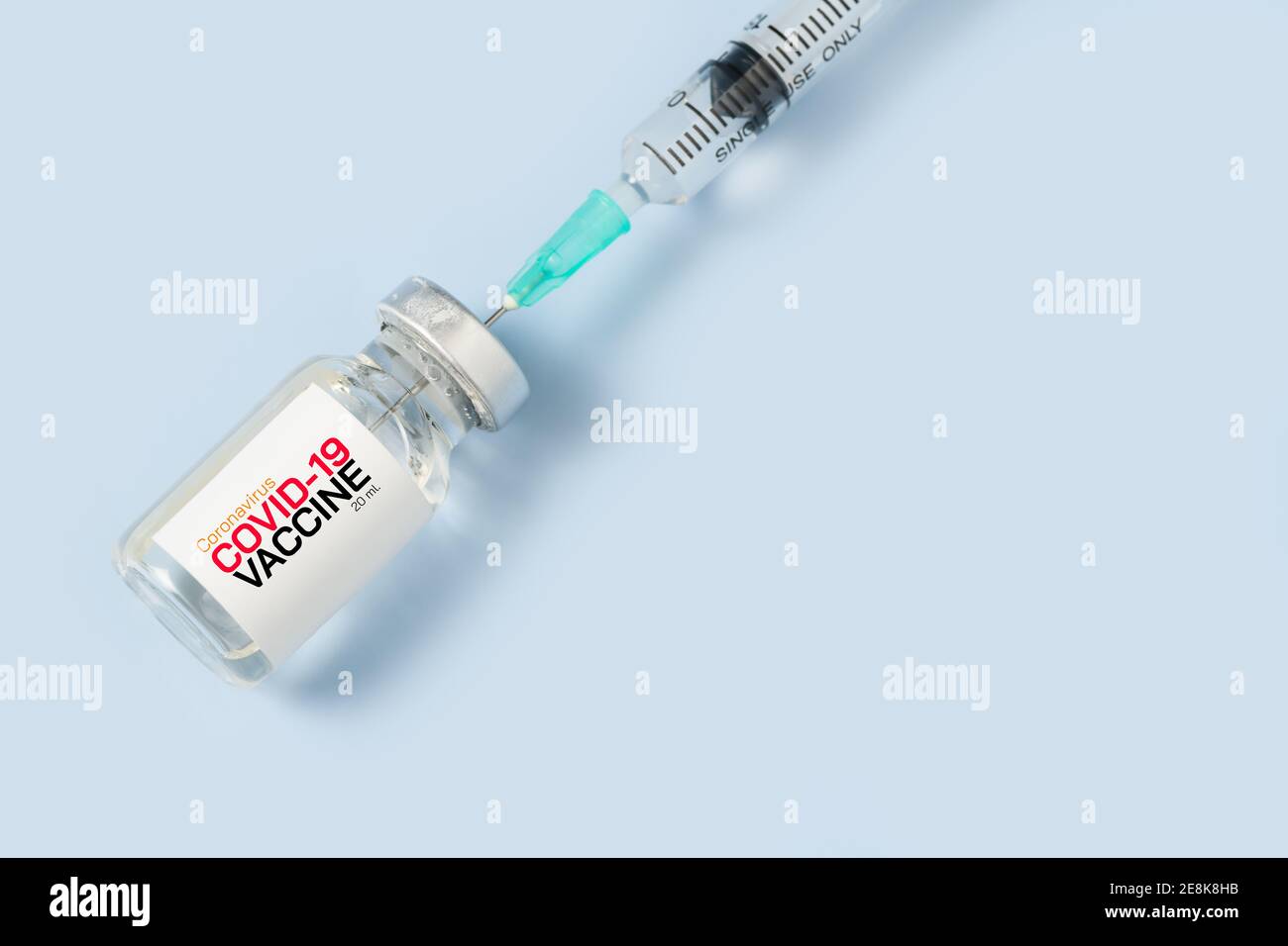 Closed up of Syringe and covid-19 vaccine on blue background,Medical ...