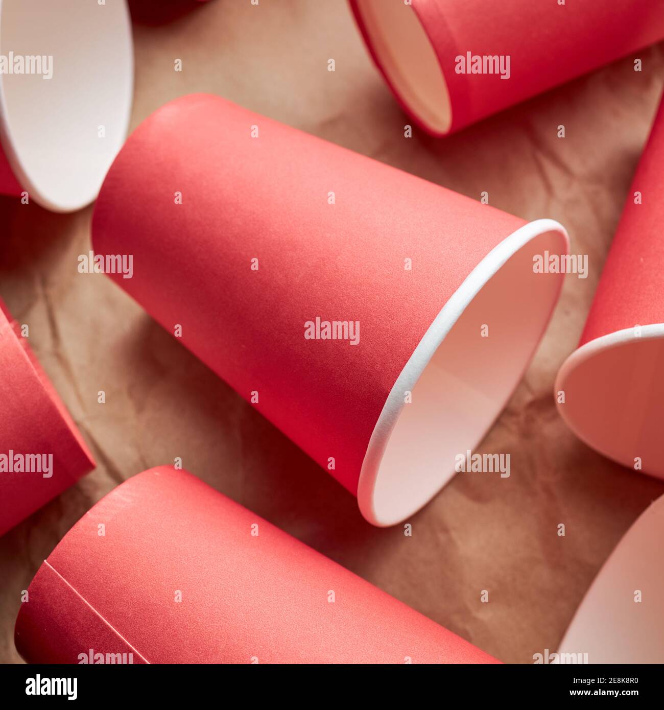 pile of disposable red paper cups on paper background. eco friendly ...
