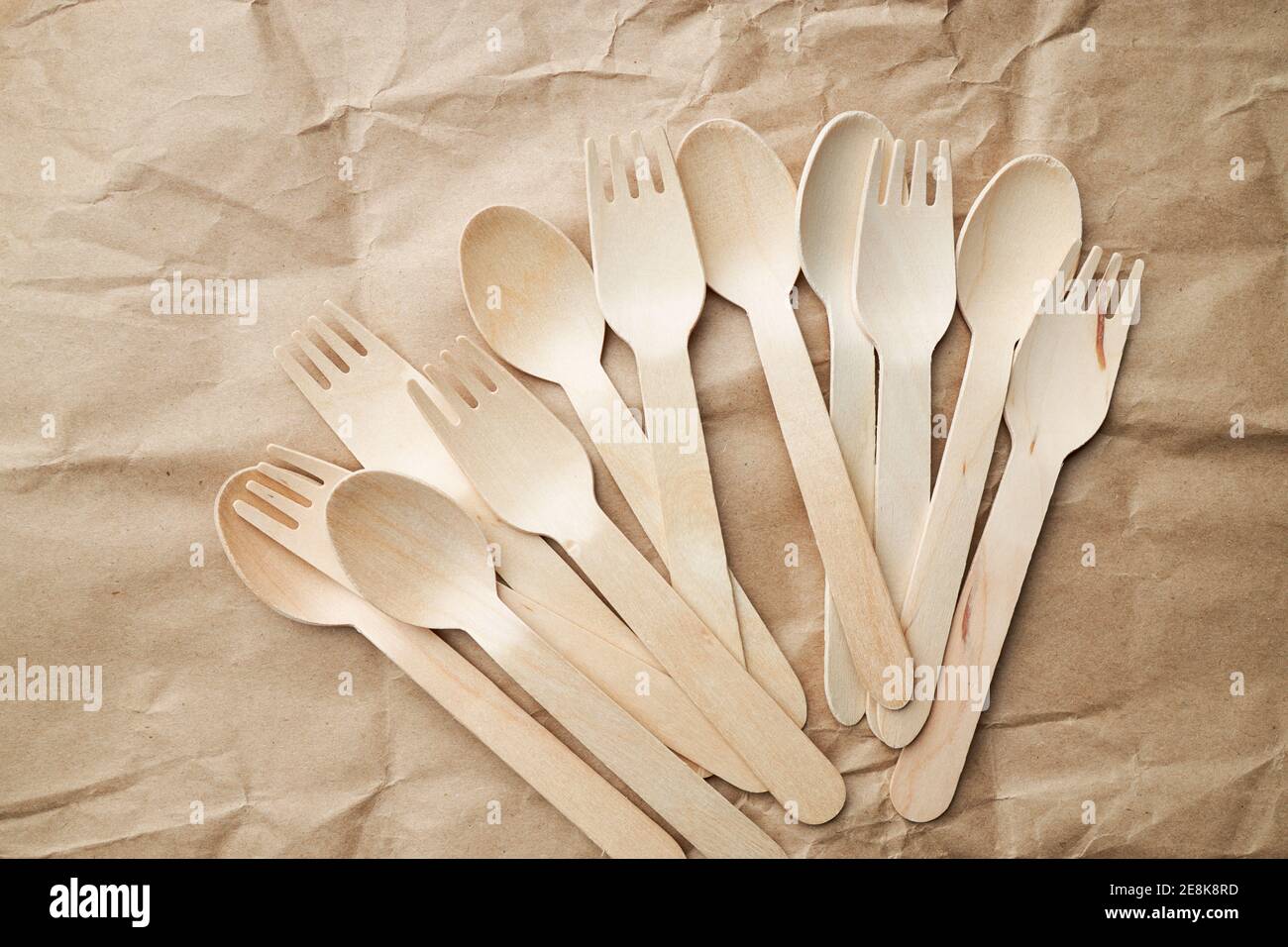 eco friendly disposable kitchenware utensils on paper background. look from above. wooden forks. eco friendly concept. copy space Stock Photo