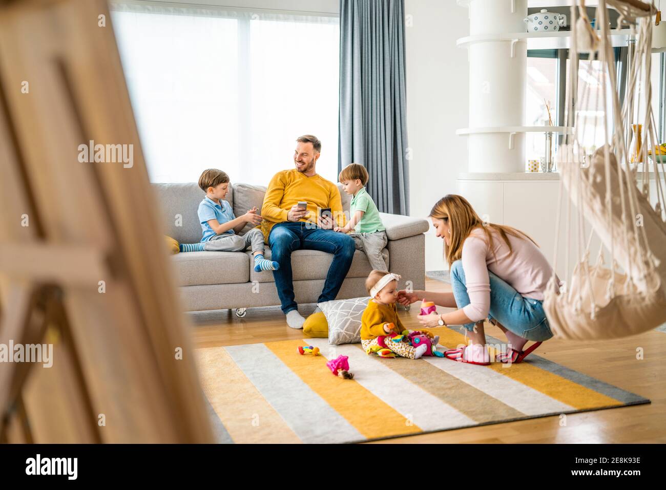 Happy young family spending time together at home Stock Photo