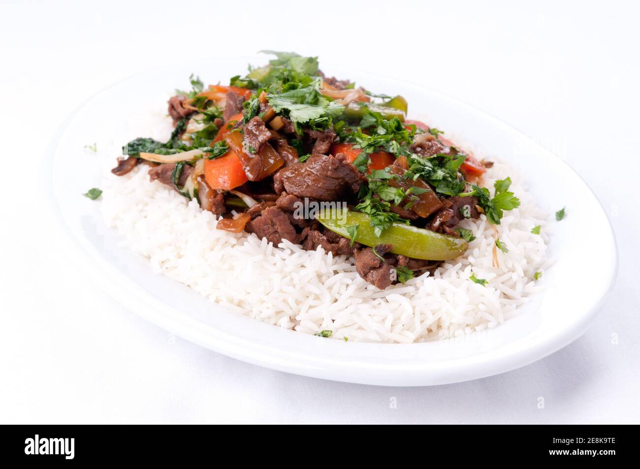 Homemade beef stir fry with flank steak, fresh vegetables, and cilantro