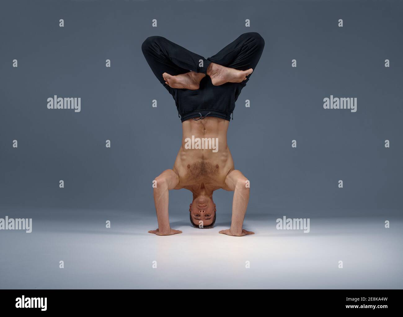 Male yoga stands on his head, hands and legs Stock Photo Alamy