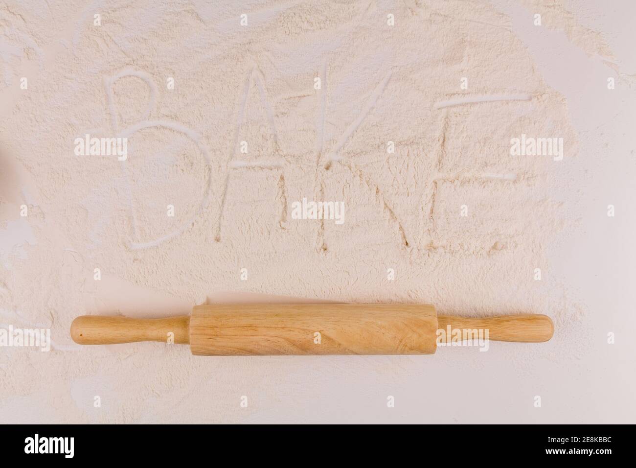 a word baked goods on white background flour with rolling pin on kitchen table Stock Photo Alamy