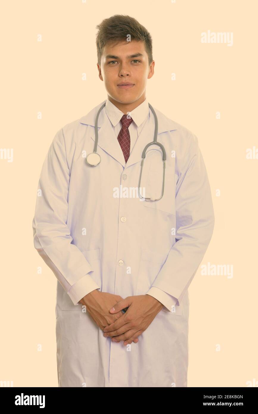 Studio shot of young handsome man doctor standing Stock Photo - Alamy