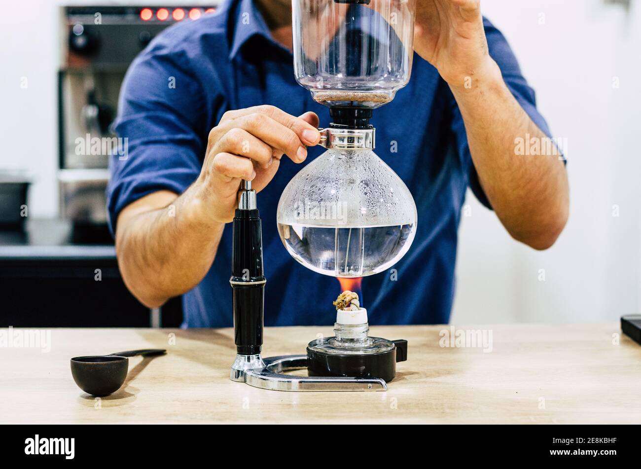 https://c8.alamy.com/comp/2E8KBHF/professional-coffee-maker-barista-using-coffee-siphon-brewing-hot-espresso-at-coffee-shop-2E8KBHF.jpg