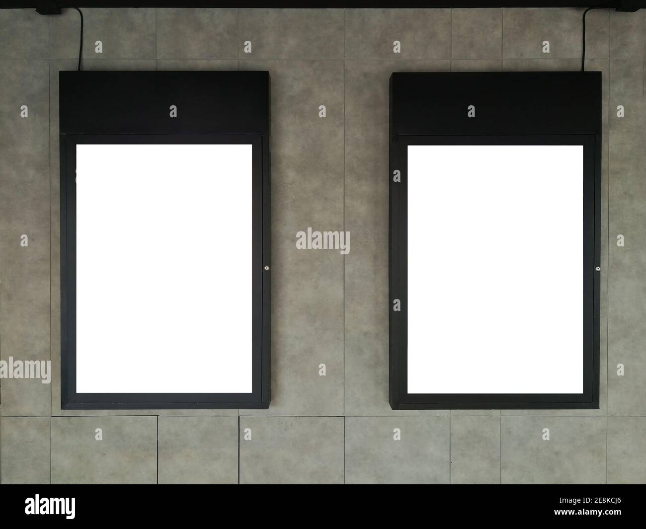 Soft focus on Two Black frame advertising signs with white background on bare cement or concrete wall Stock Photo