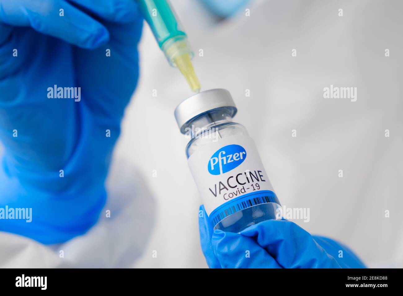 Pfizer coronavirus Vaccine and syringe in the bottle or vial for injection in doctors hands. Covid-19, SARS-Cov-2 prevention, January 2021, San Stock Photo