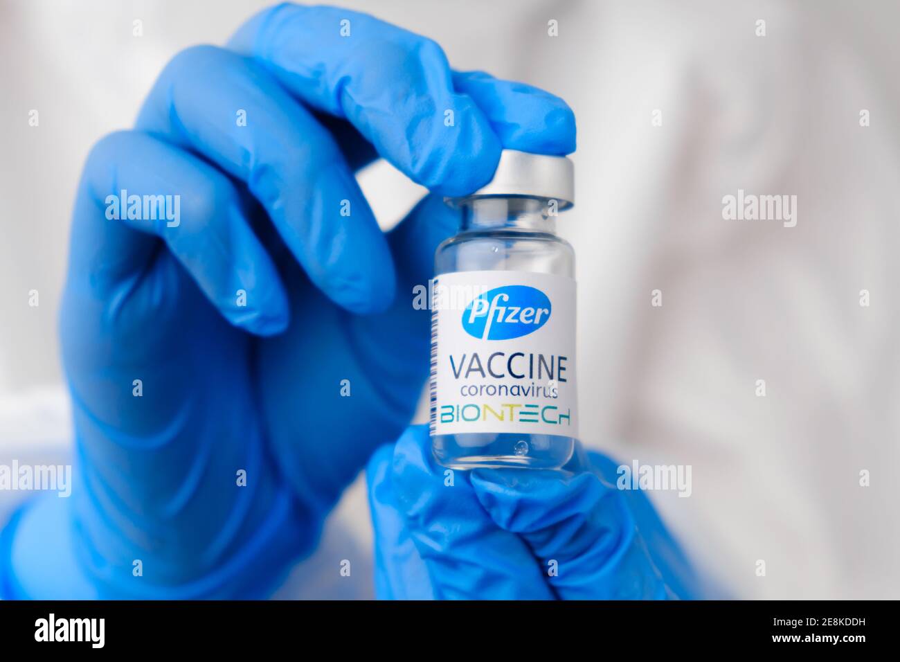 Pfizer and Biontech coronavirus vaccine in doctors or nurses hands in blue rubber gloves. Prevention of sars-cov-2 or Covid-19, January 2021, San Stock Photo