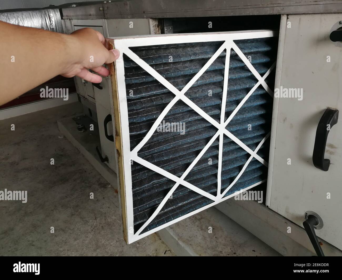 Soft Focus to Filter of Air handing Unit, Technician checking a Pre-filter of air handling unit for replacement a new filter - HVAC maintenance Stock Photo
