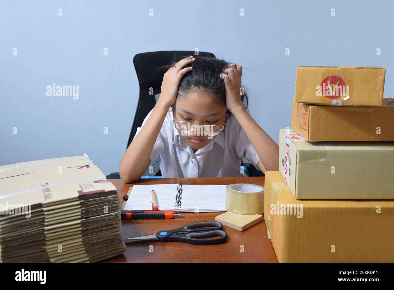 Asian Teenage women are stressed about accepting orders and delivering products to customers. - online shopping SME entrepreneur or online selling con Stock Photo