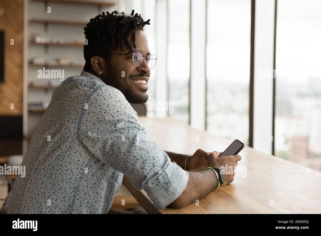 Stylish young black guy enjoy weekend at home with smartphone Stock Photo