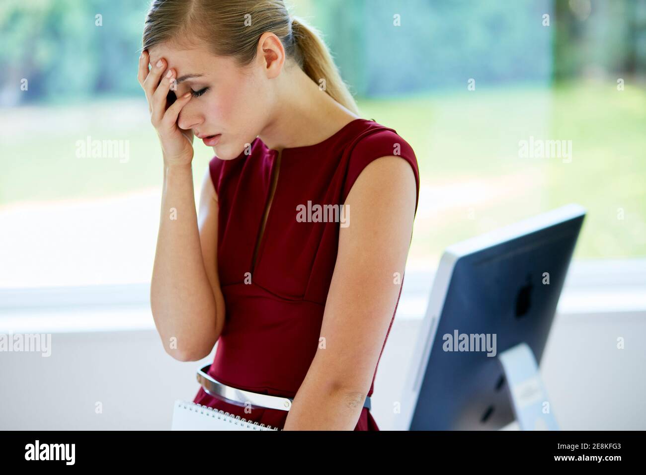 Stressed woman at work Stock Photo