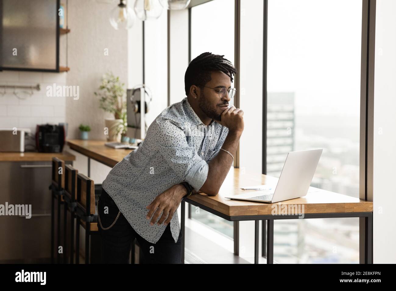 Focused afro american guy study web search result using laptop Stock Photo