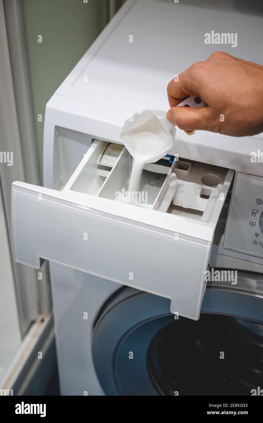 hand pouring detergent powder into the drawer of a washing machine Stock  Photo - Alamy