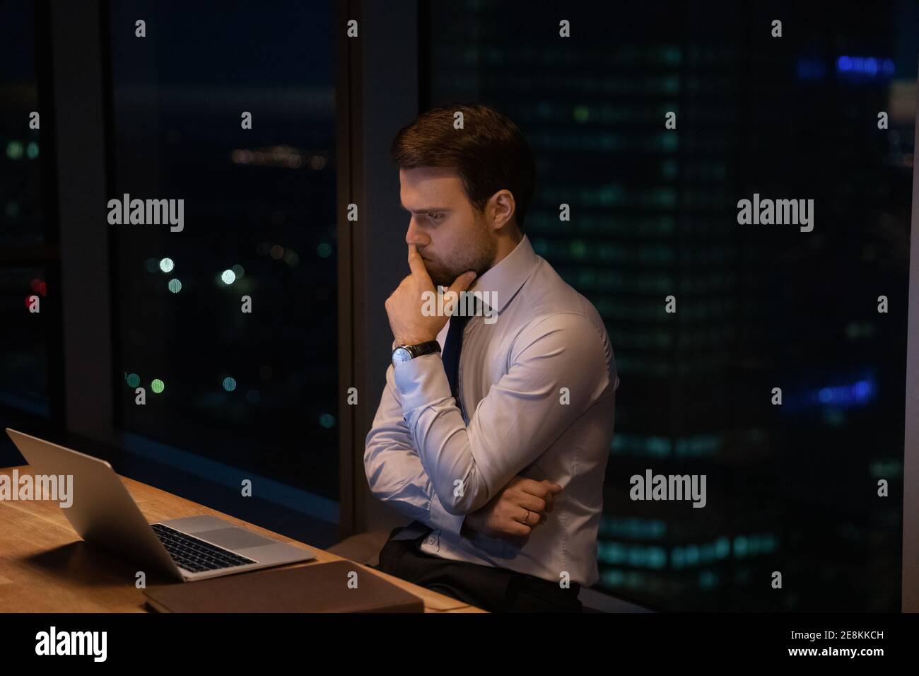 Doubtful businessman ponder by computer hesitate before making risky decision Stock Photo