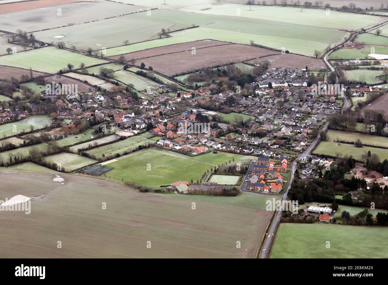 aerial view of Bishop Monkton village near Ripon on a frosty January day, with the cricket ground and village hall prominent in the foreground Stock Photo