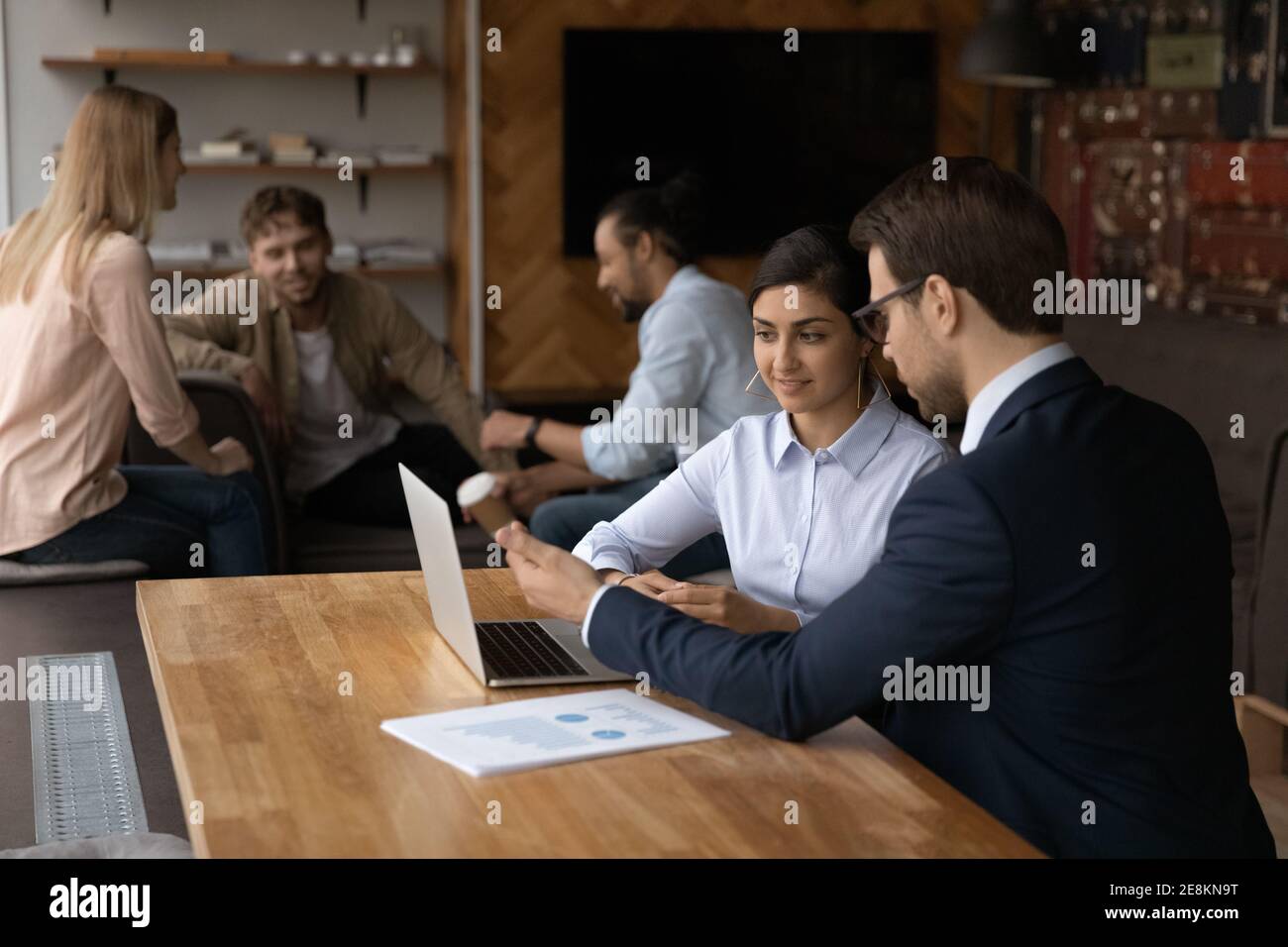 Confident leader instruct young mixed race woman new staff member Stock Photo